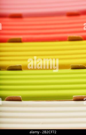 Plasticine in a box of multi-colored pieces in full screen, material for modeling. Close up. Stock Photo