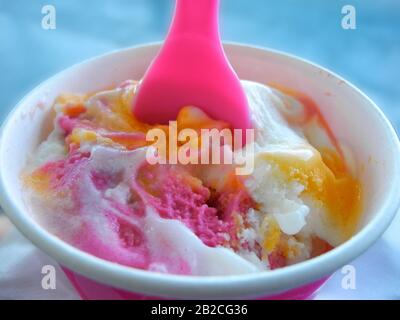 Typical colorful Hawaiian Shaved Rainbow Ice cream with spoon Stock Photo