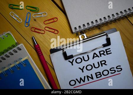 You Are Your Own Boss write on a paperwork isolated on wooden background. Stock Photo