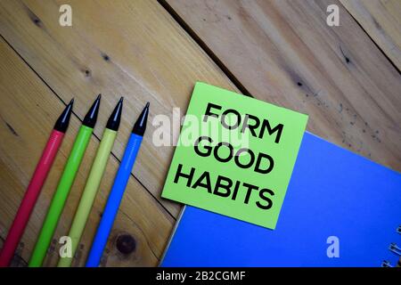 Form Good Habits write on a sticky note isolated on wooden background. Stock Photo