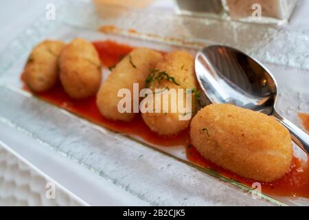 deep fried traditional potato and ham croquettes served as part of a tapas meal in a restaurant in Lanzarote canary islands spain Stock Photo