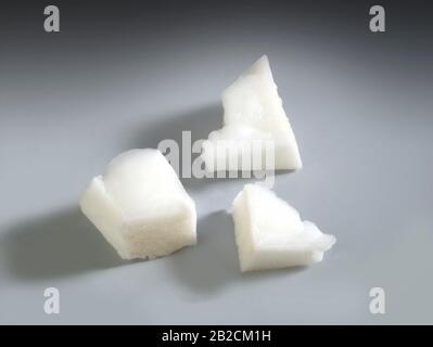 studio shot of three pieces of coconut on a gray background Stock Photo