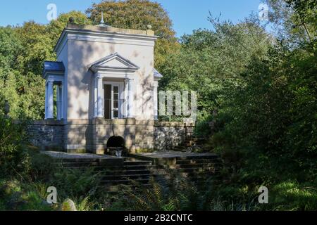 Stone steps leading up to The Nymphaeum in the woodlands on a sunny autumn day at Oakfield Park, Raphoe, Northern Ireland. Stock Photo