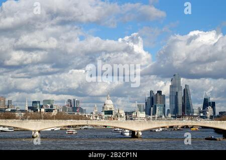 The skyline  of the City of London with the River Thames in the foreground on a sunny spring day England UK Stock Photo