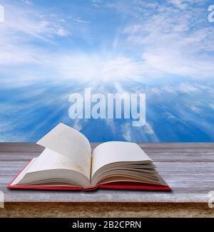 Open book on table and sky Stock Photo