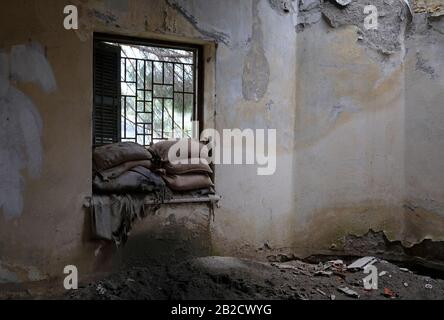 Sandbags piled up at a window of a house in the buffer zone 'Green Line' in Nicosia, Cyprus Stock Photo