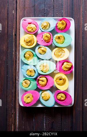 Colored hard-boiled eggs easter tradition, naturally dyed eggs for easter holiday using natural ingredients, top view flat lay composition Stock Photo