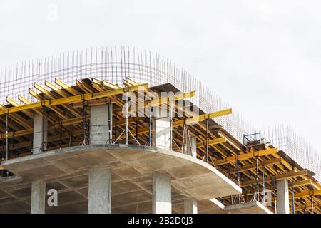 Construction of buildings using monolithic technology. Reinforced concrete frame of the building, reinforcement, formwork for pouring concrete Stock Photo