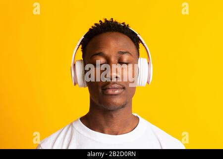 Happy african american man listening to music Stock Photo