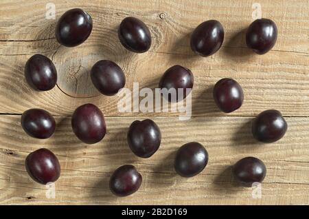 Plums on wooden background, top view Stock Photo