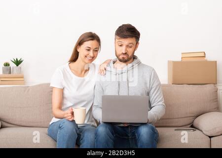 Happy young couple discussing repair concept in new home Stock Photo