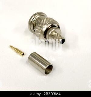 COAXIAL ANTENNA CABLE CONNECTOR, METAL PLUG  - closeup images, isolated white background ideal for composition with radiocommunications theme. Stock Photo