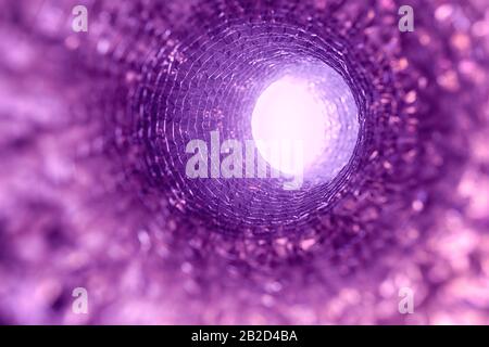 Going after death through pink-purple tunnel, into better world, in direction of bright light. Stock Photo