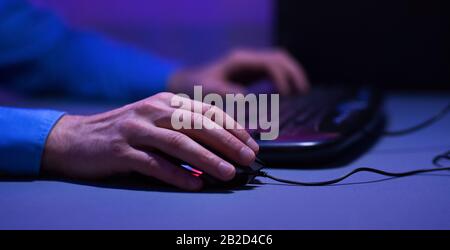 Unrecognizable Gamer Using Keyboard And PC Mouse Playing Games, Closeup Stock Photo