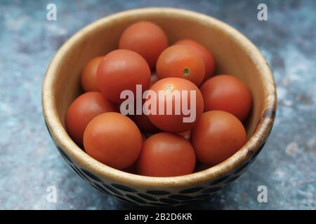 Close up of cherry tomato in a bowl on table  Stock Photo