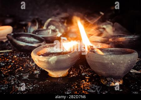 Burning oil lamps at temple. Traditional offering in buddhist and hindu temple Stock Photo