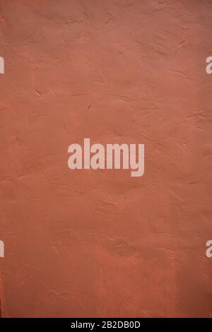 A stone texture wall in pink-brown paint. Stock Photo