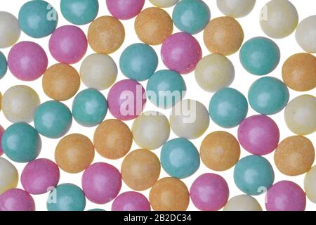 Pastel green, orange, pink and yellow sugar-coaged chocolate candy in the shape of oblate spheroid Stock Photo