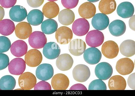 Pastel green, orange, pink and yellow sugar-coaged chocolate candy in the shape of oblate spheroid Stock Photo