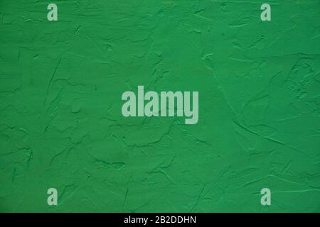 A stone wall painted in green color. Stock Photo