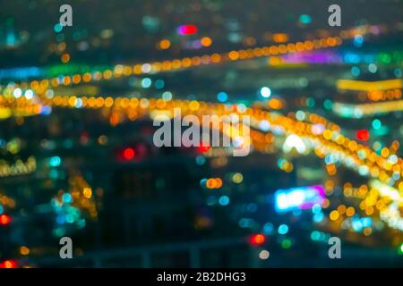 Modern city landscape. Spectacular panorama of the night city from a height. Blurry defocused multi-colored lights. Bokeh. Stock Photo