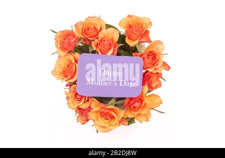 Mother's Day sign, roses orange in heart shape on white background, spring. Greeting card template Stock Photo