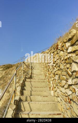 A stone staircase on a steep mountain slope. A tough climb up Stock Photo