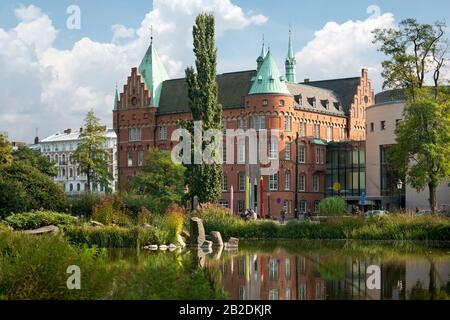 View of the city library in Malmo, Sweden. View with reflection of Malmo City Library, across the Lilla dammen lake. Stock Photo