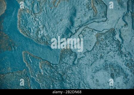 A stone wall painted in turquoise color. Stock Photo