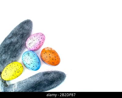 Colored easter eggs and bunny ears on a white background. Stock Photo