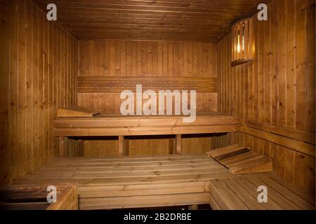 Wooden panelled Sauna with benches Stock Photo
