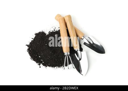 Fertile soil and gardening tools isolated on white background Stock Photo