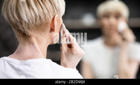 Unrecognizable Woman Using Cotton Pads In Bathroom Indoor, Back-View, Panorama Stock Photo