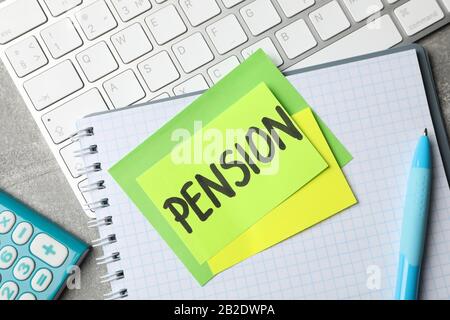 Stickers with inscription Pension on workplace background, top view Stock Photo