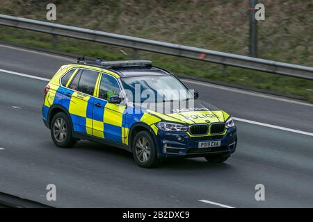 Police car emergency services vehicles driving on the M6 motorway near Preston in Lancashire, UK Stock Photo