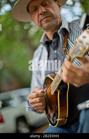 Happy middle aged man playing a mandolin Stock Photo