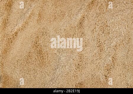 Natural crumpled leather texture, golden colored background Stock Photo