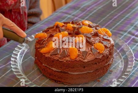 A decorated chocolate and orange sponge cake. Stock Photo