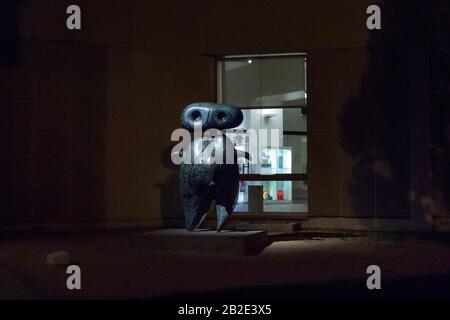 The statue 'Personnage' by Joan Miro is seen at night in front of the Fundacio Joan Miro in Barcelona Spain. Stock Photo