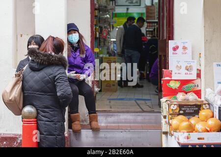 London / UK - February 22nd 2020  - Women wear protective face masks outside New Loon Moon grocery store in Chinatown, London Stock Photo