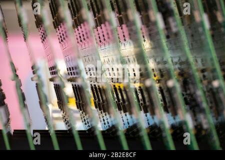 Printed Circuit Boards (PCB) stacked in vertical rack Stock Photo