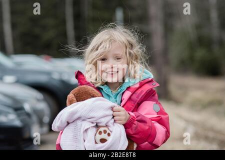 candid portrait of a young girl smiling with messy hair Stock Photo