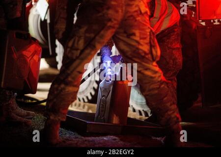 03 March 2020, Saxony-Anhalt, Burg: A soldier of Logistics Battalion 171 and a US Army soldier fill a reserve canister with fuel in Clausewitz Barracks after refuelling a US Army vehicle. The military vehicle is being transferred from a depot in Belgium to Poland for the US-led exercise 'Defender Europe 2020' and was refuelled at the site by Bundeswehr soldiers. As part of the large-scale exercise, around 20,000 soldiers are to be transferred from the USA across Germany to Eastern Europe. In addition, several more exercises are planned in Germany, Poland, Georgia and the Baltic States, bringin Stock Photo