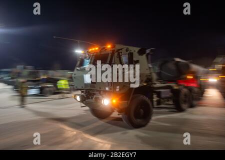 03 March 2020, Saxony-Anhalt, Burg: A US Army truck leaves Clausewitz Barracks. The military vehicle is being transferred from a depot in Belgium to Poland for the US-led exercise 'Defender Europe 2020' and was refuelled at the site by Bundeswehr soldiers. As part of the large-scale exercise, around 20,000 soldiers are to be transferred from the USA across Germany to Eastern Europe. In addition, several more exercises are planned in Germany, Poland, Georgia and the Baltic States, bringing the total number of soldiers from 18 nations involved to 37,000. Photo: Klaus-Dietmar Gabbert/dpa-Zentralb Stock Photo