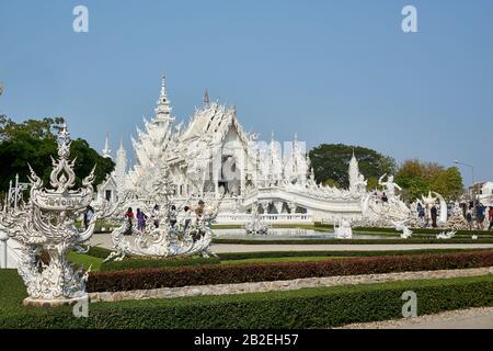 Chiang Rai, Thailand - February.10.2020: Tourists visit White Temple Rong Khun temple, Chiang Rai province, northern Thailand Stock Photo