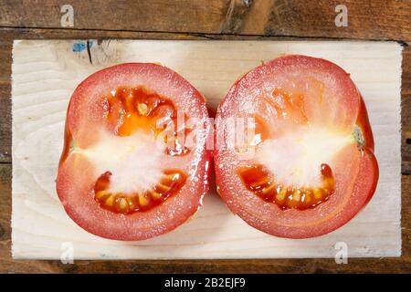 Fresh Tomatos on a wooden cutboard Stock Photo