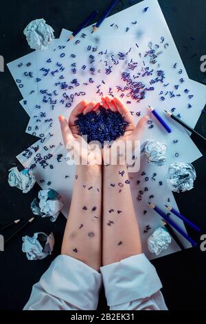 Spilled letters in hands of a writer, flat lay with hands, creative workplace Stock Photo