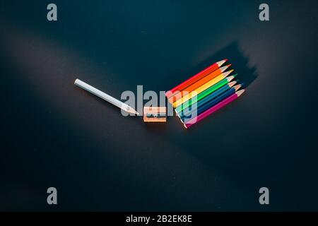Light spectrum from white pencil going through sharpening to a rainbow of pencils, creative flat lay Stock Photo