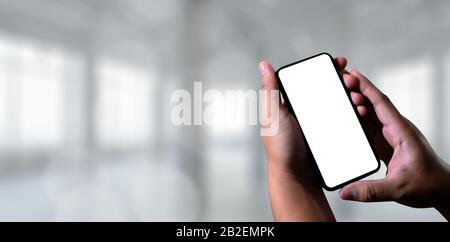 Closeup image of male hands with smartphone sms message on chat man typing an sms message to his friends Stock Photo