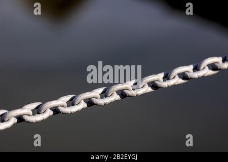 metal chain isolated on anthracite background, just the middle in focus Stock Photo
